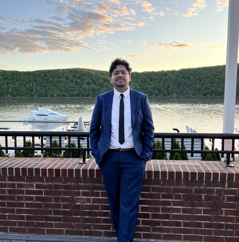 Suyash Tandon on a waterfront terrace at dusk